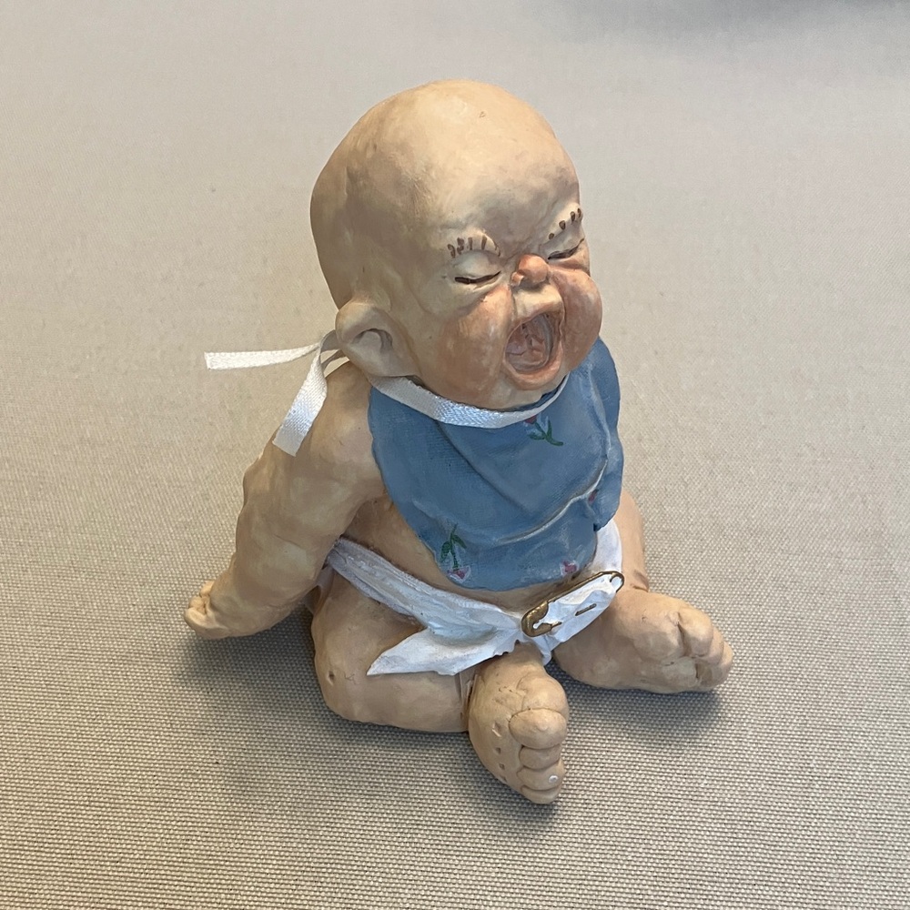 Handcrafted Baby crying Figurine with Blue Bib
